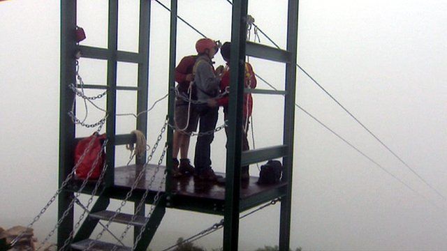 Man prepares to go on a zip wire slide