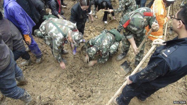 Paramilitary policemen search for victims