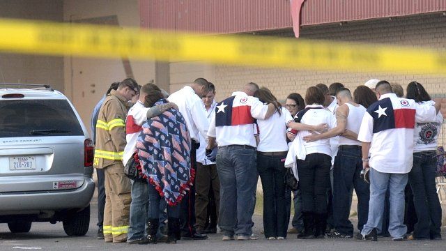 Parade participants console each other