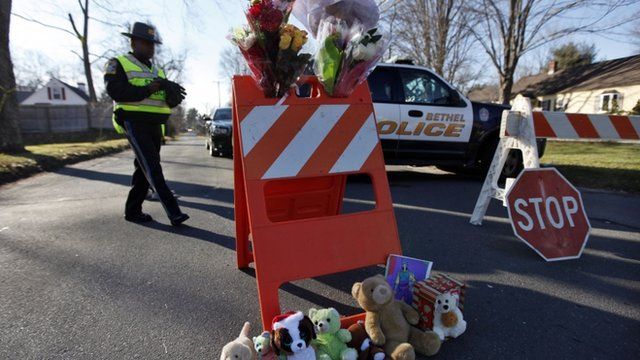 A police roadblock turned into a makeshift memorial in Newtown
