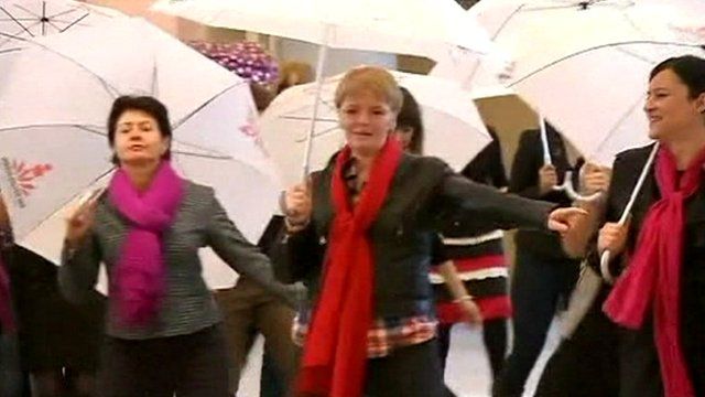 Women dancing with umbrellas