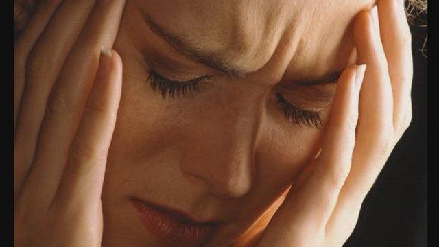 woman stressed with head in hands