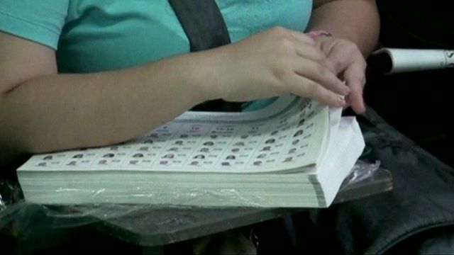 Woman checking voting papers