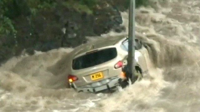 Vehicle surrounded by flood water