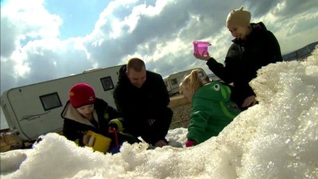 A family plays in the snow