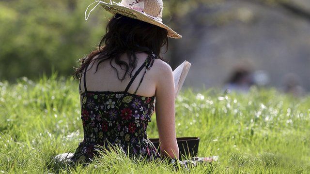 Woman reads a book on Primrose Hill