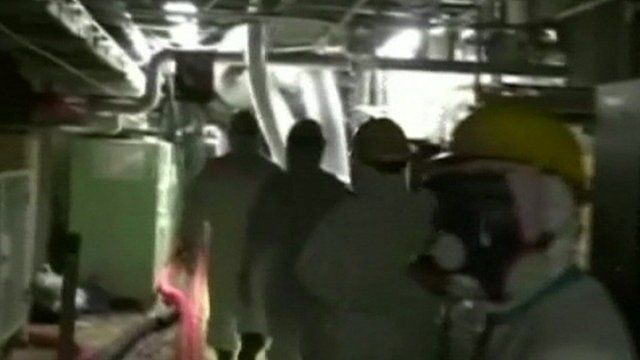 A worker in protective clothing at the Fukushima nuclear plant.