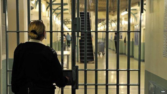 A prison officer locks a door at Wormwood Scrubs