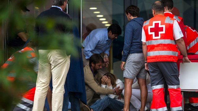Relatives of passengers involved in the train crash wait for news at the Cersia Building on July 25