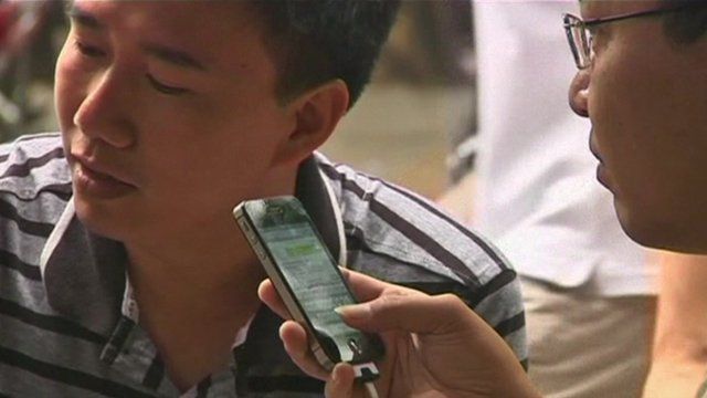 Vietnamese men using internet on mobile phones