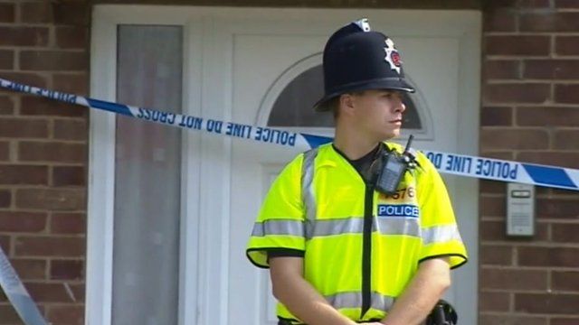 Police officer outside flat in Colchester