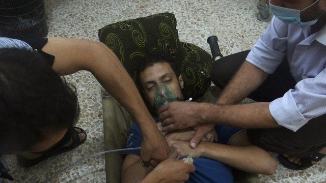 A man, affected by what activists say is nerve gas, breathes through an oxygen mask in the Damascus suburb of Jesreen on August 21.