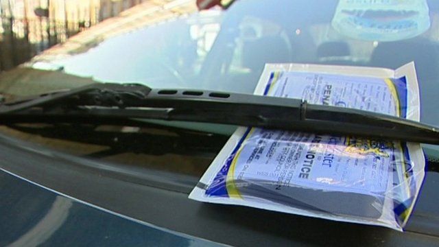 A parking ticket on a car windscreen