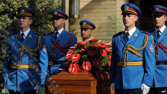 Military honour guard around coffin