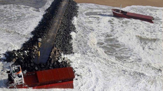 An aerial view show waves which break against a Spanish cargo ship carrying fertiliser, broken in two, off the beach in Anglet on the Atlantic Coast of France