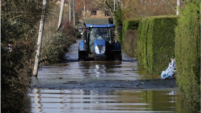 A tractor drives in flood water at Burrowbridge on the Somerset Levels on February 9, 2014