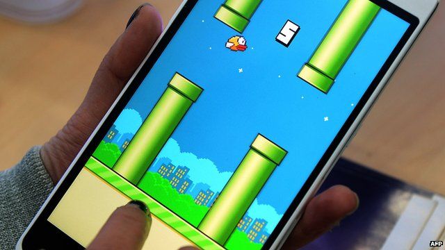 A person playing mobile app Flappy Bird