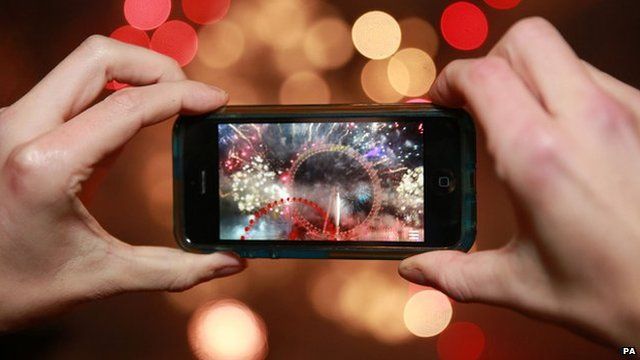 A person taking a photograph on a smartphone