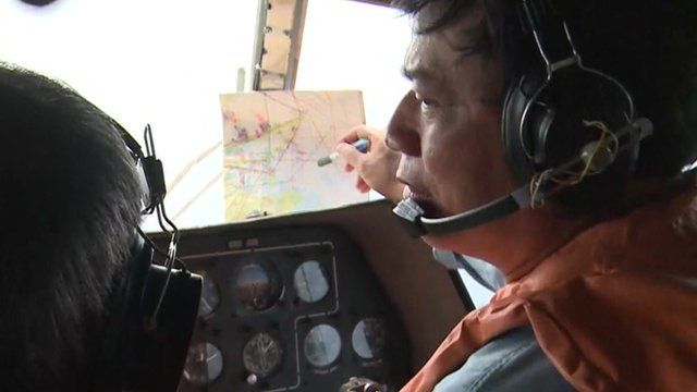 Pilot looks out of the helicopter window
