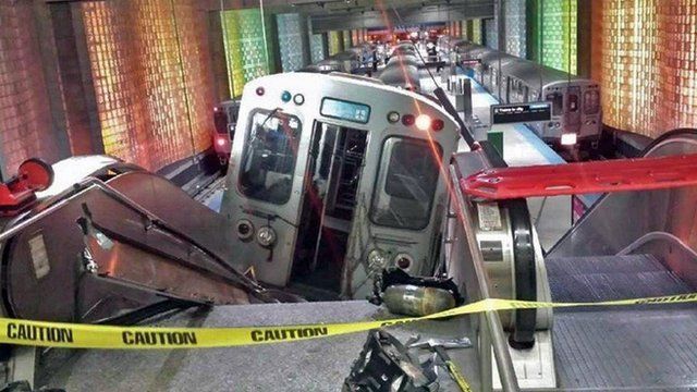 A Chicago Transit Authority train car rests on an escalator at the O'Hare Airport station after it derailed early Monday