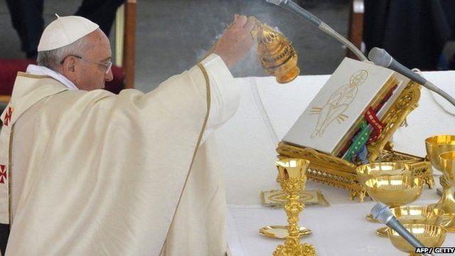 Pope Francis prepares the Eucharist during the canonisation mass of Popes John XXIII and John Paul II at St Peter's