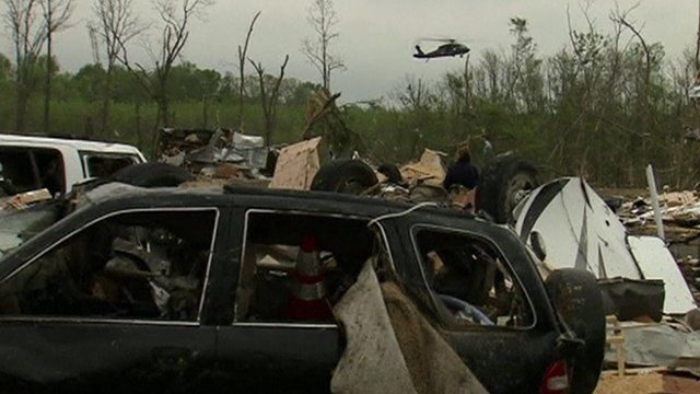 A helicopter in the background of aftermath from the tornado