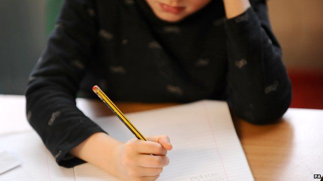 Child writing at a desk