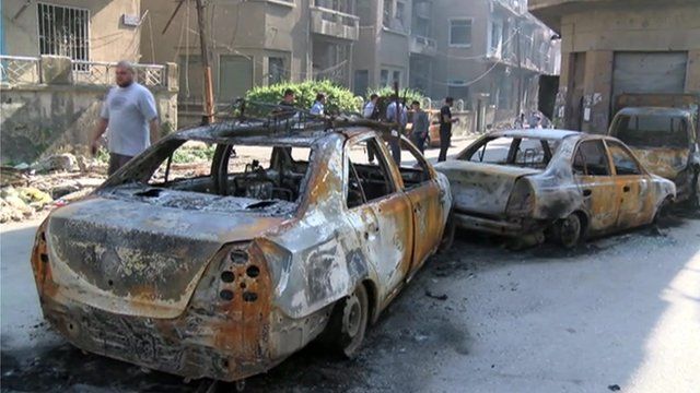 Burnt out cars in Homs