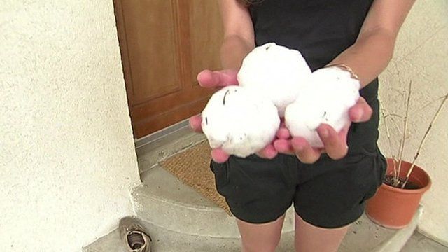 Woman holding large hailstones