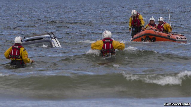 Car in sea with RNLI