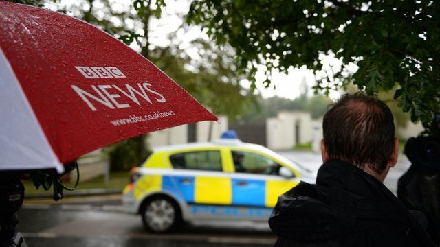 A police car passes the Charters Estate in Sunningdale, Berkshire, where Sir Cliff Richard has an apartment