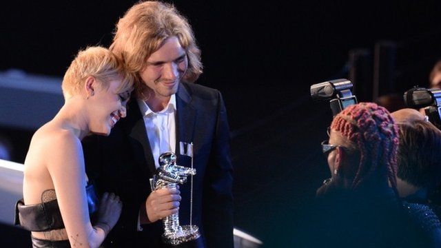 My Friend's Place representative Jesse (2nd L) accepts Video of the Year with singer Miley Cyrus (L) for "Wrecking Ball"