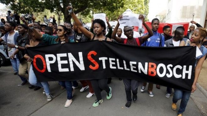 Students march with a banner during a protest at South Africa's Stellenbosch University in Stellenbosch -1 September 2015