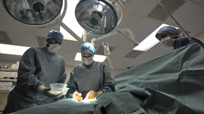 BBC file photo from 2011 of a nurse, surgeon and anaesthetist performing an operation at Chelsea and Westminster hospital.