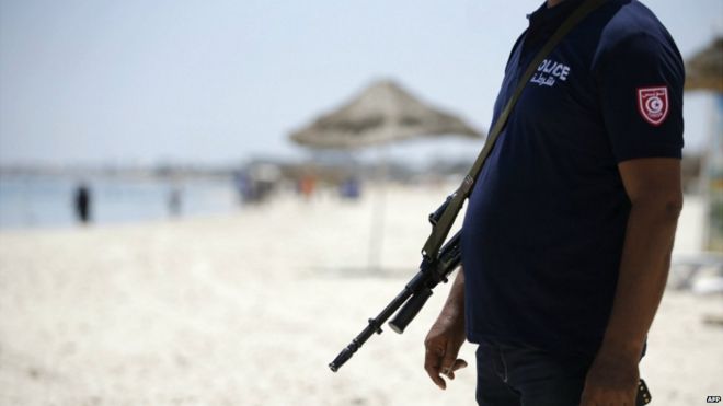 A Tunisian policeman patrols the beach in Sousse - 28 June 2015