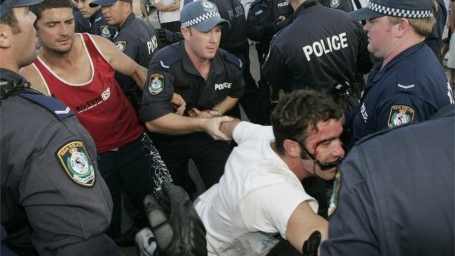 Police restrain a man in Cronulla (11 Dec 2005)