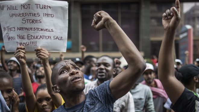 Students shout slogans outside the African National Congress ruling party (ANC) headquarters, on 22 October 2015, in Johannesburg, South Africa, during a demonstration against university fee hikes