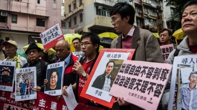 Protesters hold up missing person notices of (L-R) Mighty Current publisher of books critical of China company"s general manager Lui Bo and colleagues Cheung Jiping, Gui Minhai, Lee Bo and Lam Wing-kei as they walk towards China"s Liaison Office in Hong Kong on January 3, 2016.