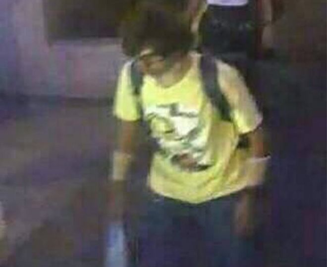 This Aug. 17, 2015, image, released by Royal Thai Police spokesman Lt. Gen. Prawut Thavornsiri shows a man wearing a yellow T-shirt near the Erawan Shrine before an explosion occurred in Bangkok, Thailand.