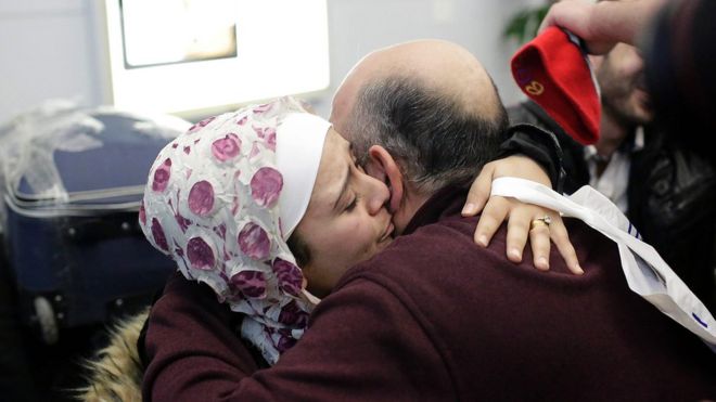 Syrian refugee Baraa Haj Khalaf (left), hugs her father Khaled Haj Khalaf as she arrives at O'Hare International Airport in Chicago, 7 February 2017