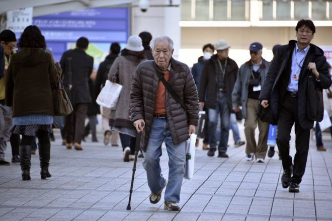 An elderly man walks with a stick in Yokohama, near Tokyo, Japan, 26 February 2016