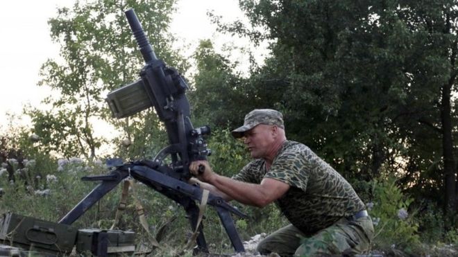 A Ukrainian government soldier fires a grenade launcher in the Donetsk region. Photo: August 2015