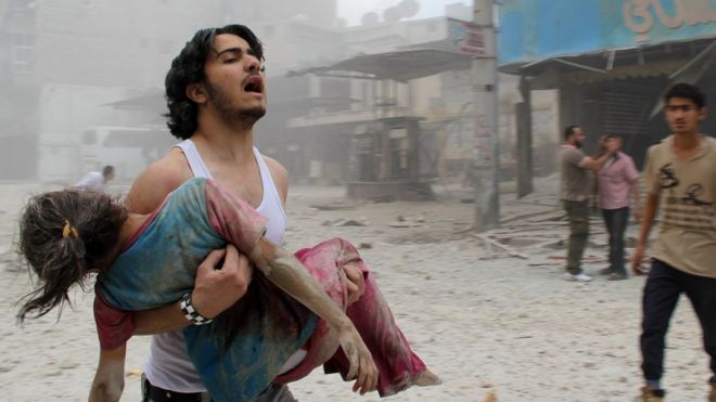 Man holds injured woman in Aleppo