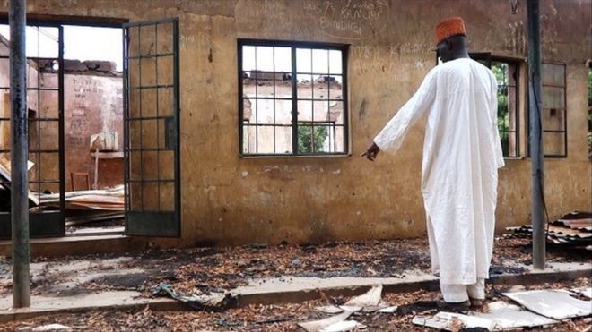 A staff inspects on August 6, 2013 a burnt student hostel in the Government Secondary School of Mamudo in northeast Nigerian Yobe state where Boko Haram gunmen launched gun and explosives attacks on student hostels on July 6, 2013, killing 41 students and a teacher