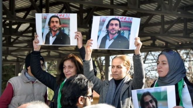 Women hold pictures of film maker Naji Jerf, who was killed on December 27, during his funeral in Gaziantep (28 December 2015)