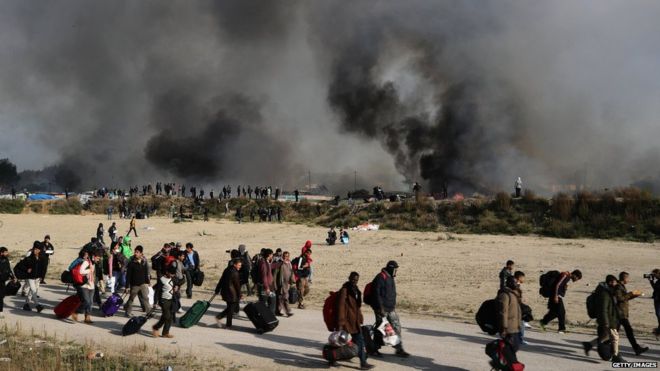 Fire breaks out in the Jungle camp as migrants prepare to leave while the authorities start to demolish the site on 26 October 2016 in Calais, France