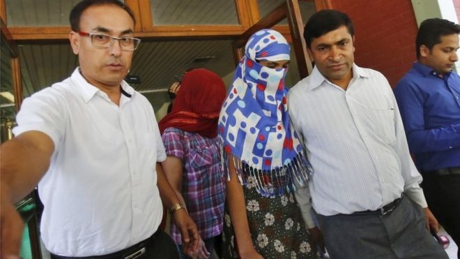 Two veiled Nepali women, who told police they were raped by a Saudi official, walk outside Nepal's embassy in New Delhi, India, September 9, 2015