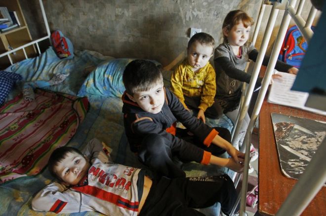 The Shevchenko children play in a hostel room after being evacuated from their home in a Donetsk suburb after shelling, 2 February