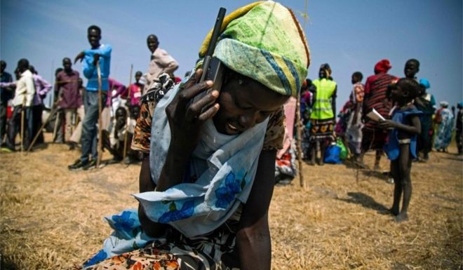 A woman from Thonyor, South Sudan, uses a satellite phone provided by ICRC (International Committee of the Red Cross) on February 3, 2016 to call her lost relatives