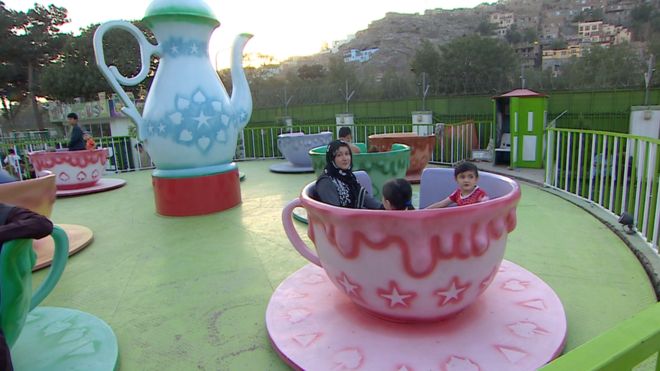 Hosnia Abdullah on a fairground ride with daughter Nazani, nine, and son Nasser, six